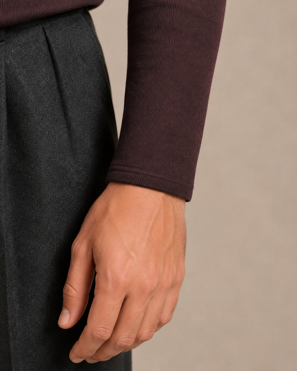 ÜRON Signature Henley in Espressobraun am Model – Detail des langen Ärmels und Ärmelabschlusses.